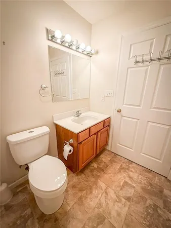 a bathroom with a sink a toilet and mirror