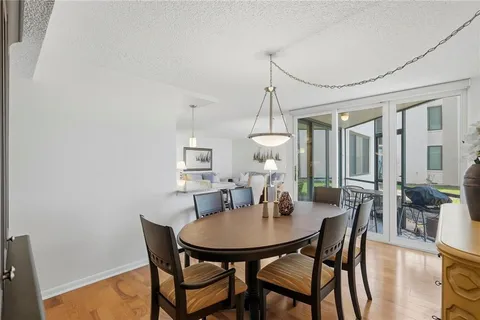 a view of a dining room with furniture window and wooden floor