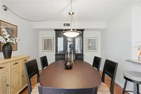 a view of a dining room with furniture a chandelier and wooden floor
