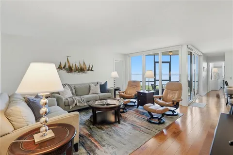 a living room with furniture rug and a large window