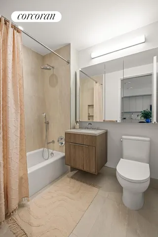 a bedroom with a large bed and a potted plant