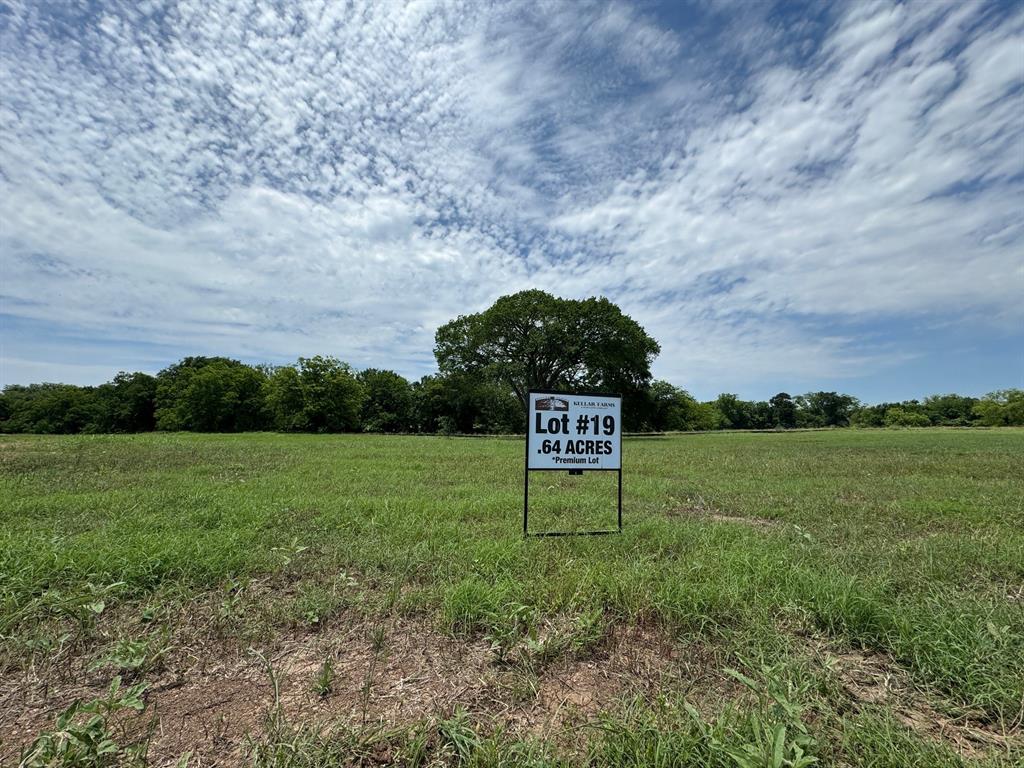 a sign board with grassy field