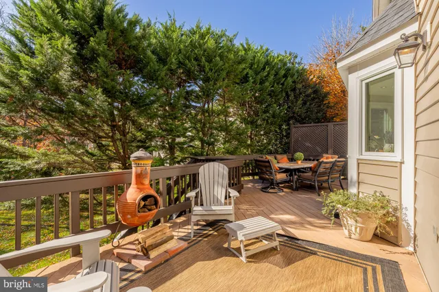 a view of a patio with wooden chairs and table in a patio