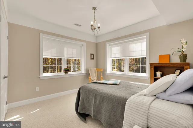 a spacious bedroom with a bed and a window