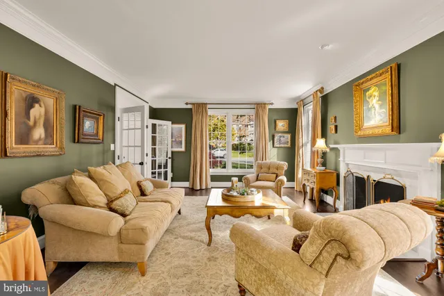 a living room with fireplace furniture and a large window