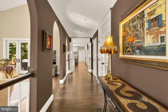a view of a hallway with wooden floor and furniture
