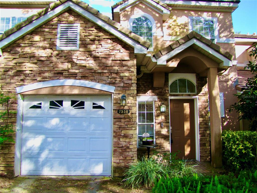7538 Bayport Road, Unit 24 Orlando, FL 32819 - Photo 1 of 1 a front view of a house with a yard