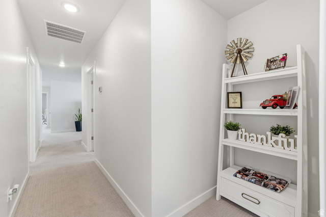 1038 South Old Towne Road Layton, UT 84041 - Photo 12 of 39 Hallway featuring recessed lighting, light neutral-toned carpeting, white walls, and white trim