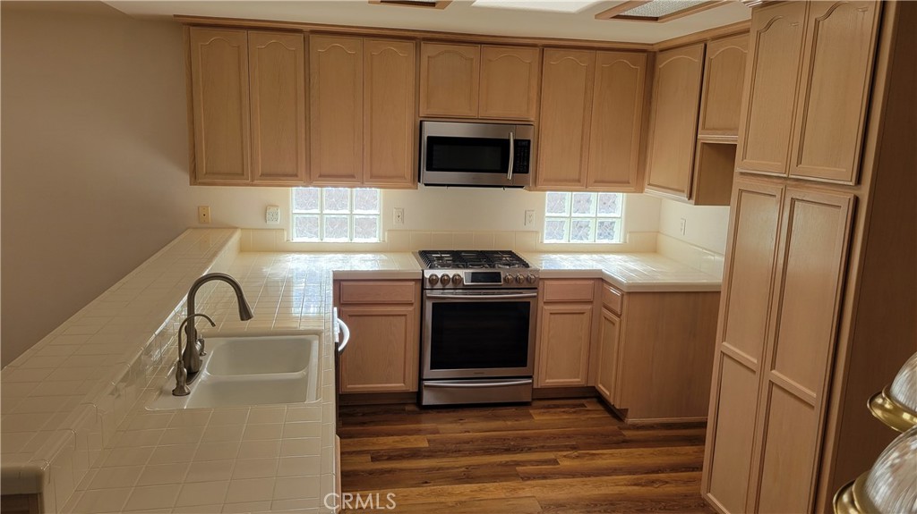 1115 Rose Court Grover Beach, CA 93433 - Photo 4 of 17 a kitchen with a sink stove and microwave
