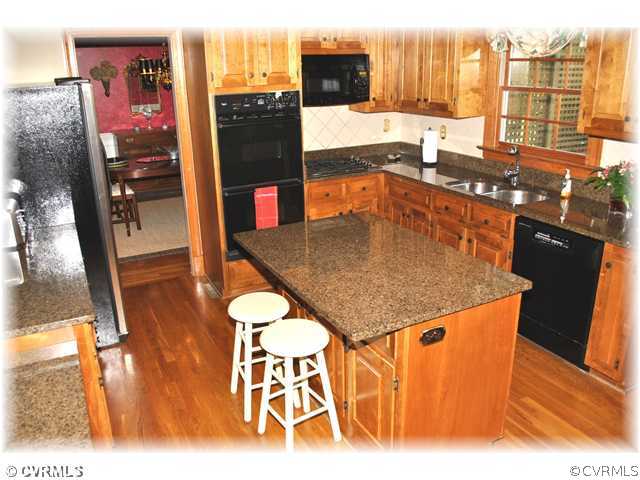 14110 Grangewood Road Midlothian, VA 23113 - Photo 4 of 12 a kitchen with stainless steel appliances granite countertop a sink and cabinets