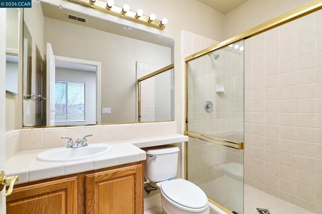 a white toilet sitting next to a bath tub