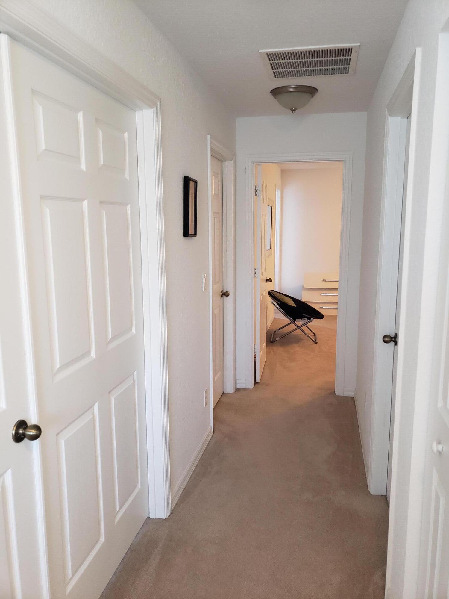 9312 Natures Way Fort Pierce, FL 34945 - Photo 11 of 16 a view of a hallway to a bedroom