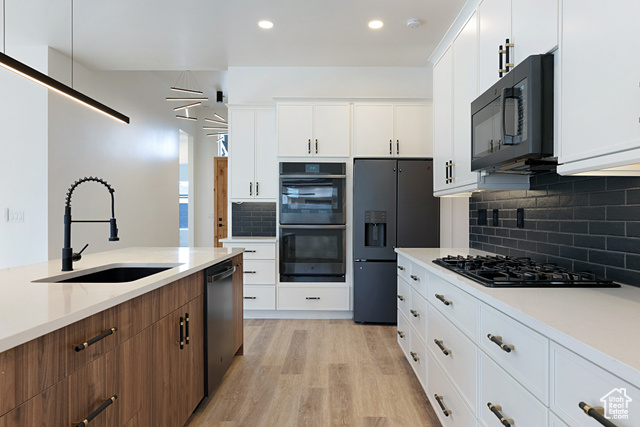 3145 Snow Cyn Road Hurricane, UT 84737 - Photo 8 of 38 Kitchen featuring black appliances, light wood-style floors, light countertops, tasteful backsplash, and recessed lighting