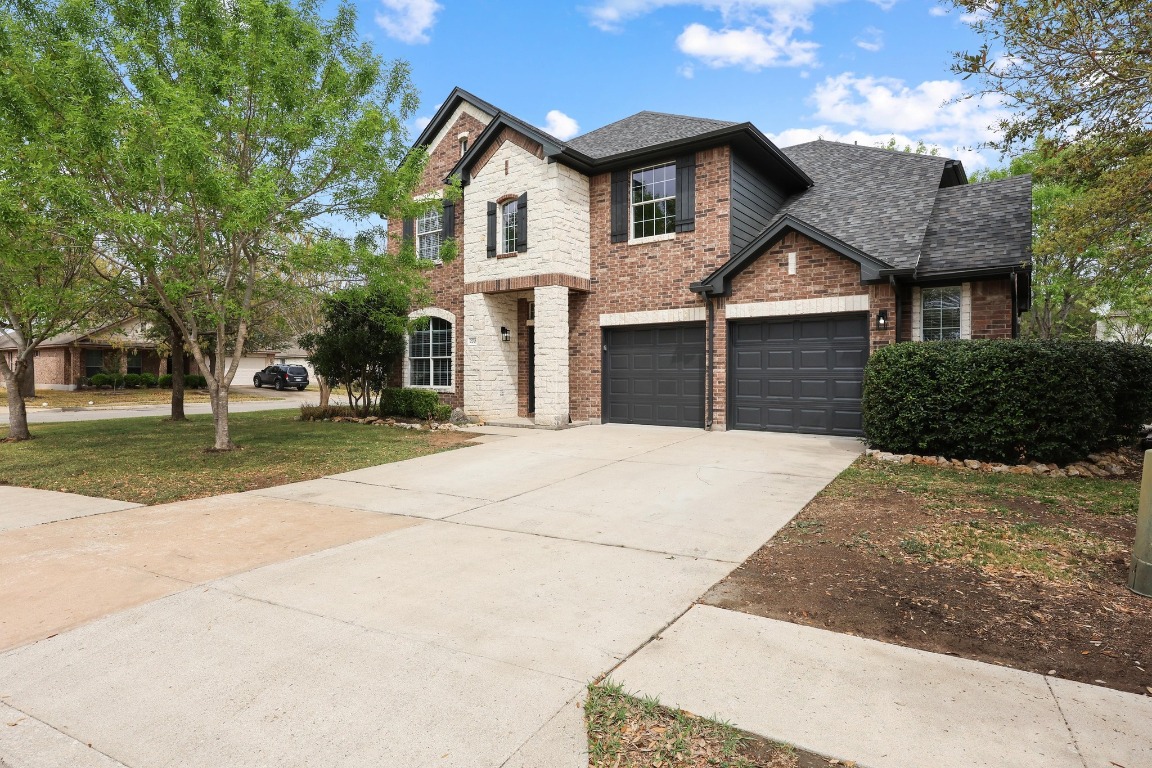 270 Lear Avenue Buda, TX 78610 - Photo 1 of 1 a front view of a house with a yard and garage