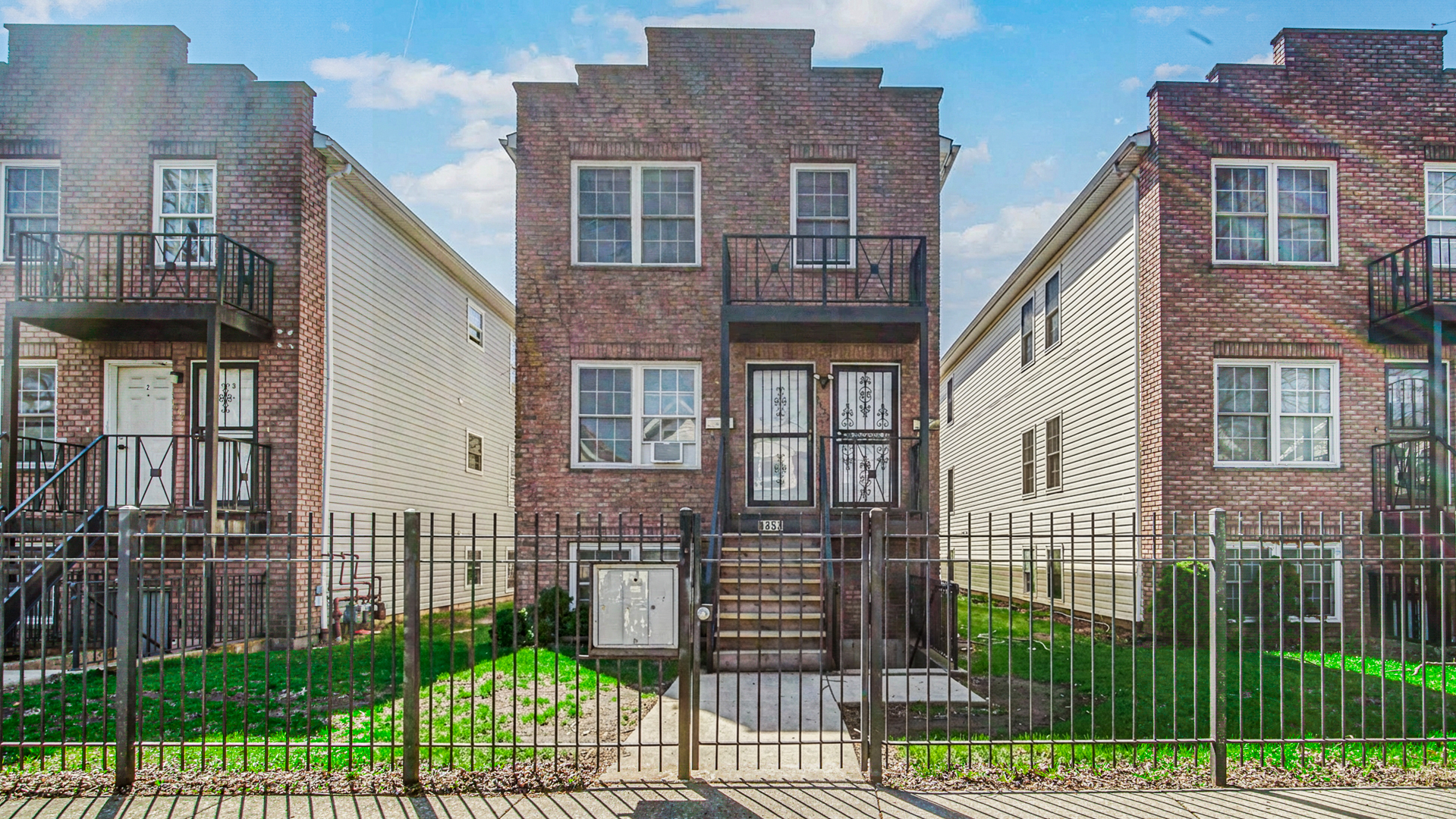 1453 East 72nd Street, Unit 3 Chicago, IL 60619 - Photo 1 of 20 a front view of a house with a garden and plants