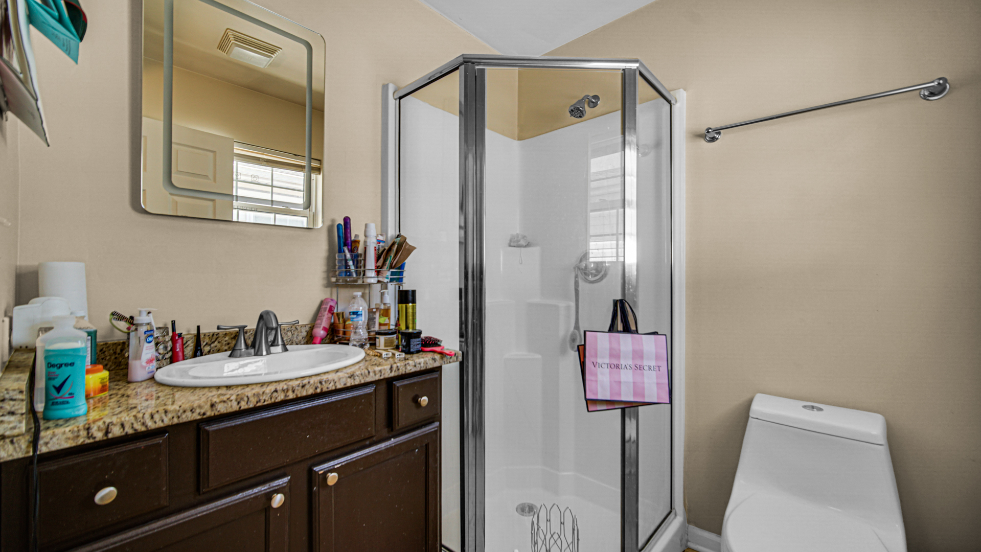 1453 East 72nd Street, Unit 3 Chicago, IL 60619 - Photo 14 of 20 a bathroom with a granite countertop sink and a mirror