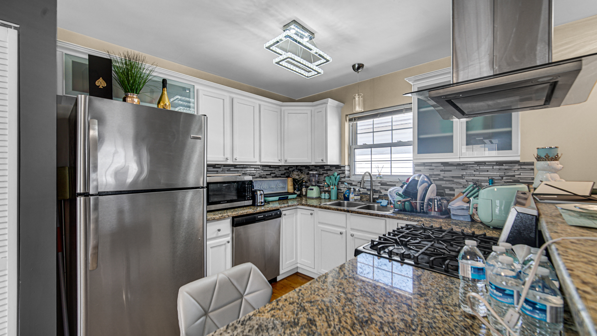 1453 East 72nd Street, Unit 3 Chicago, IL 60619 - Photo 8 of 20 a kitchen with stainless steel appliances granite countertop a refrigerator sink and stove