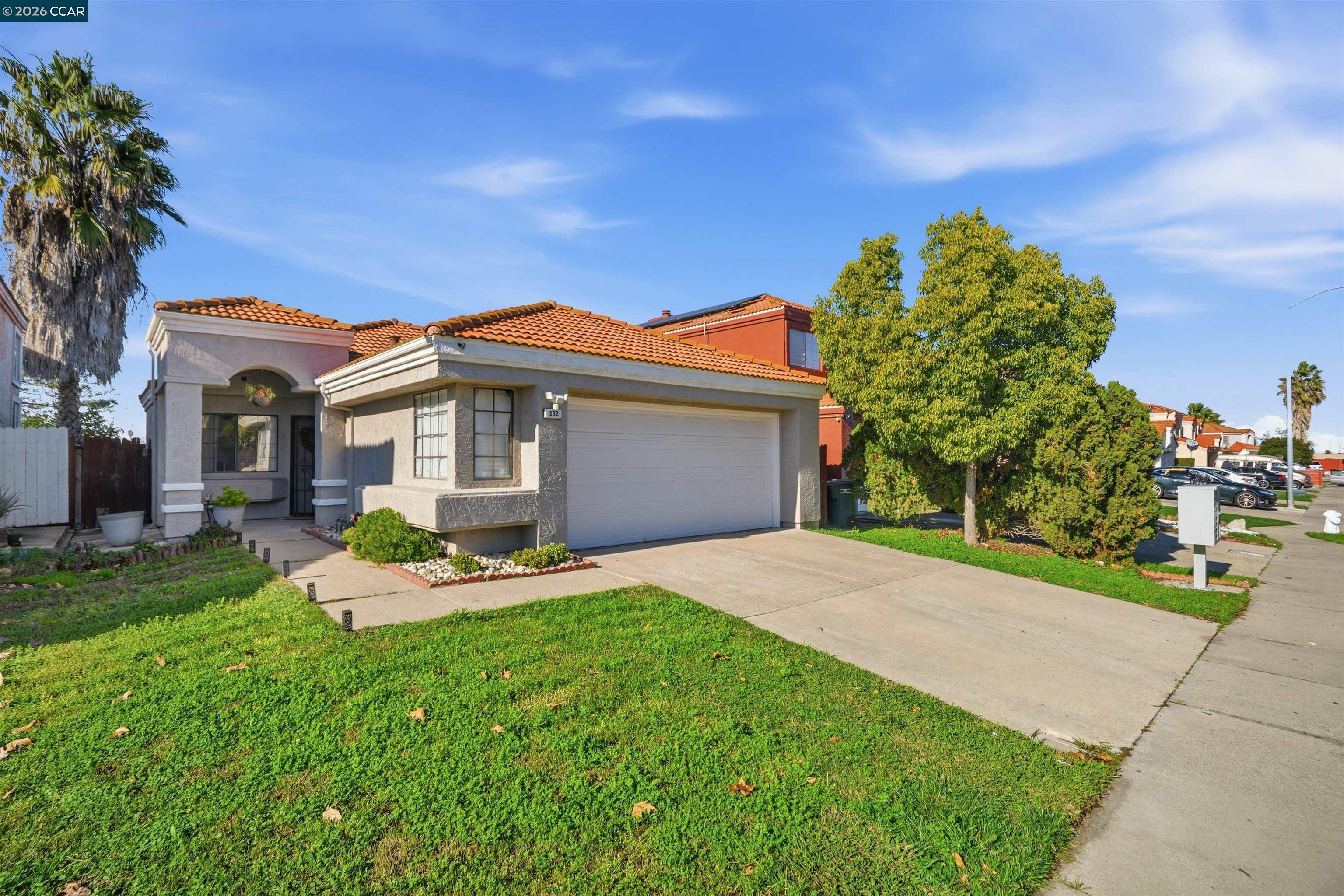 a front view of a house with a yard and garage