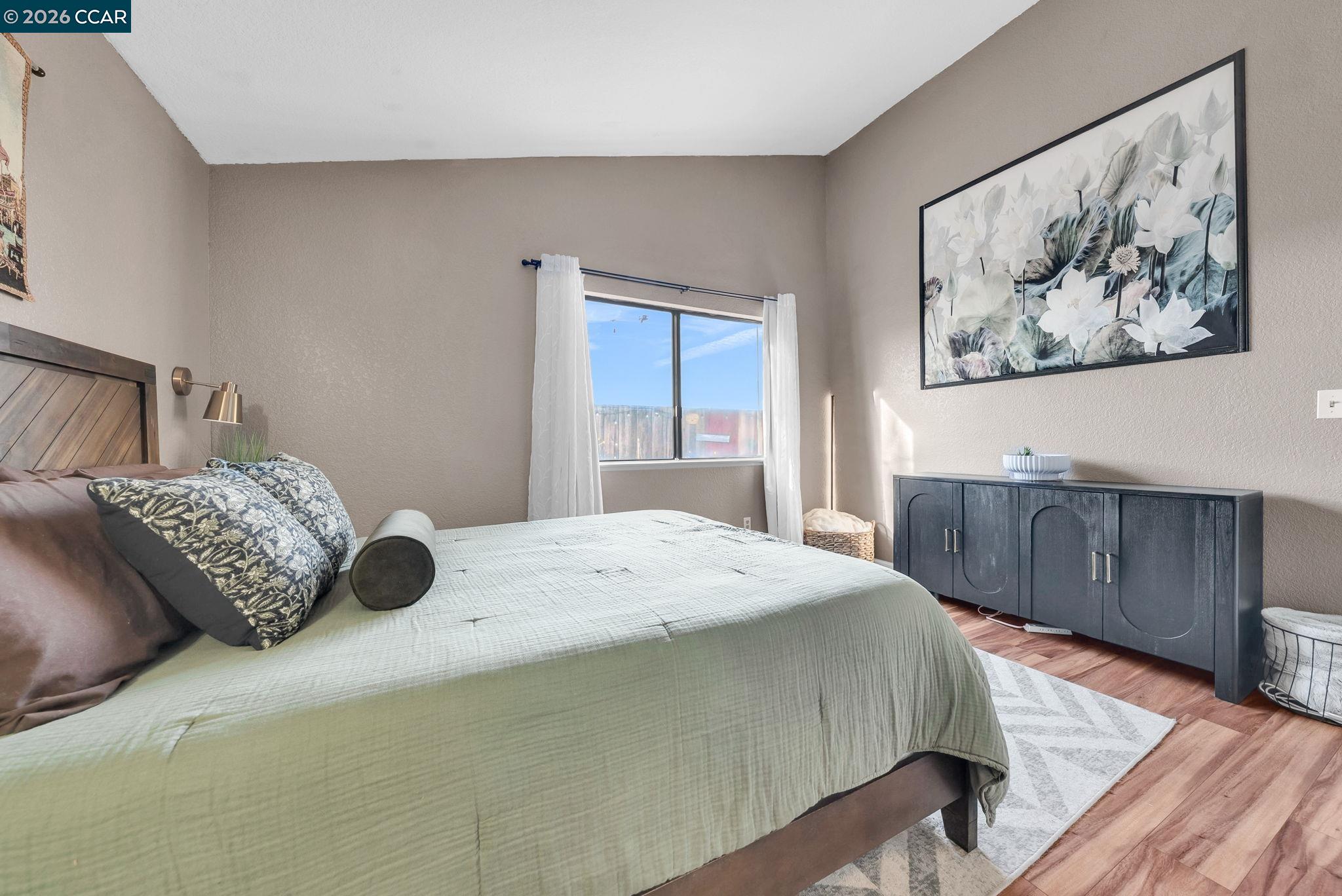 232 Case Drive Pittsburg, CA 94565 - Photo 19 of 37 a bedroom with a bed and wooden floor