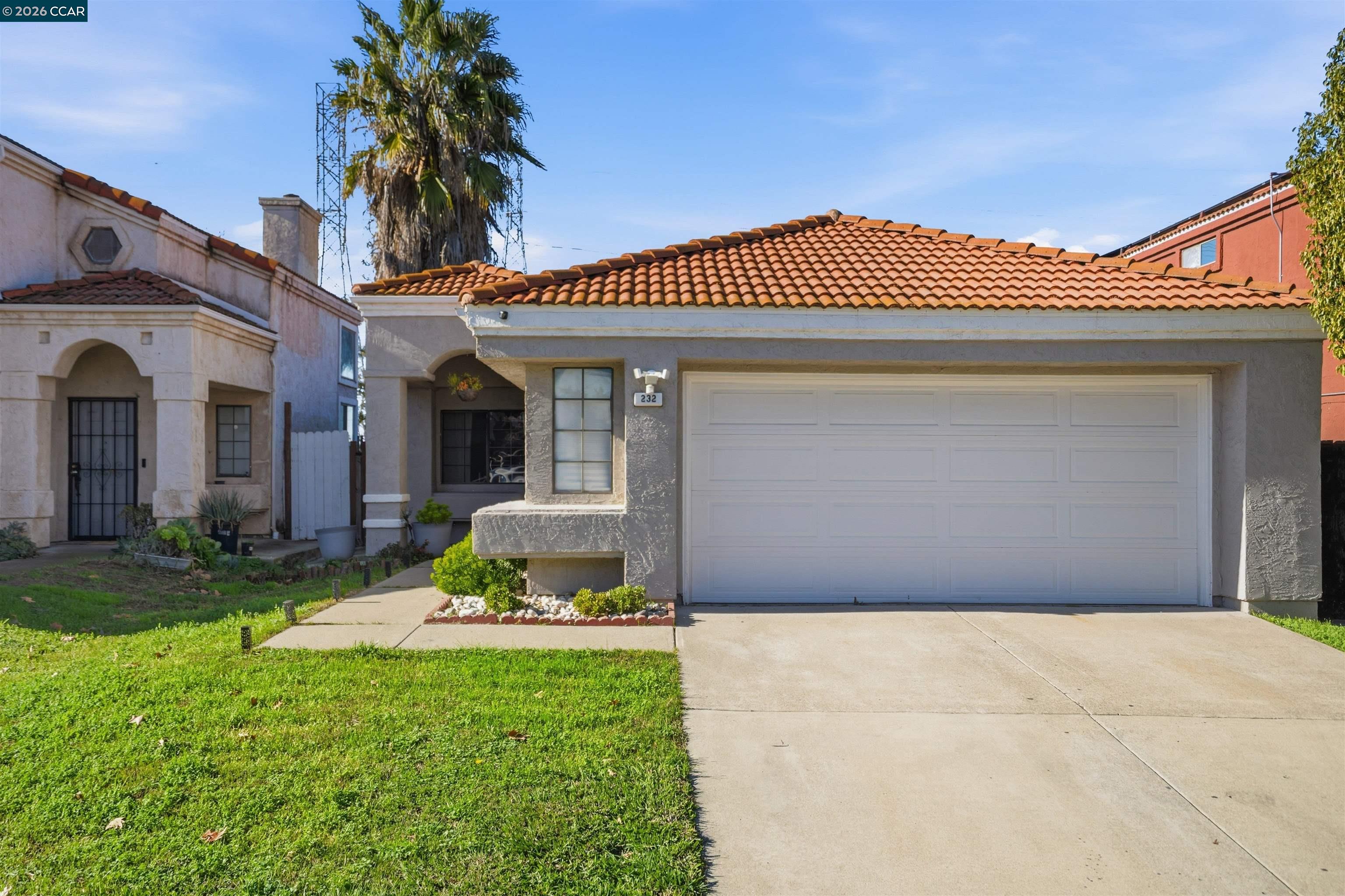 232 Case Drive Pittsburg, CA 94565 - Photo 3 of 37 a front view of a house with a garden and yard
