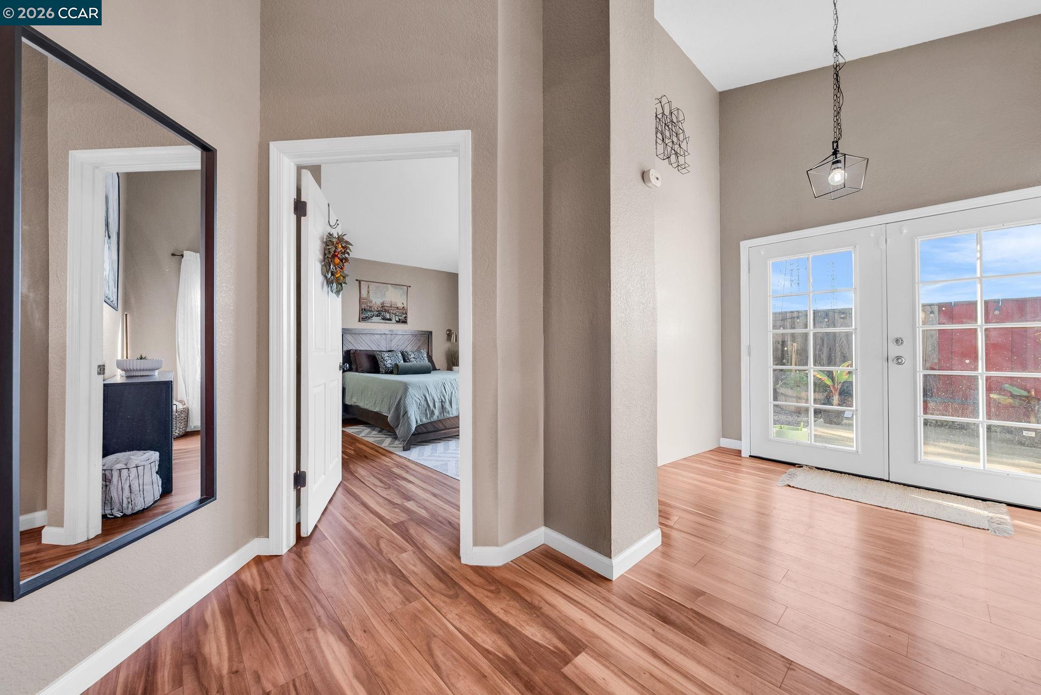 232 Case Drive Pittsburg, CA 94565 - Photo 7 of 37 a view of a hallway with wooden floor and a bedroom