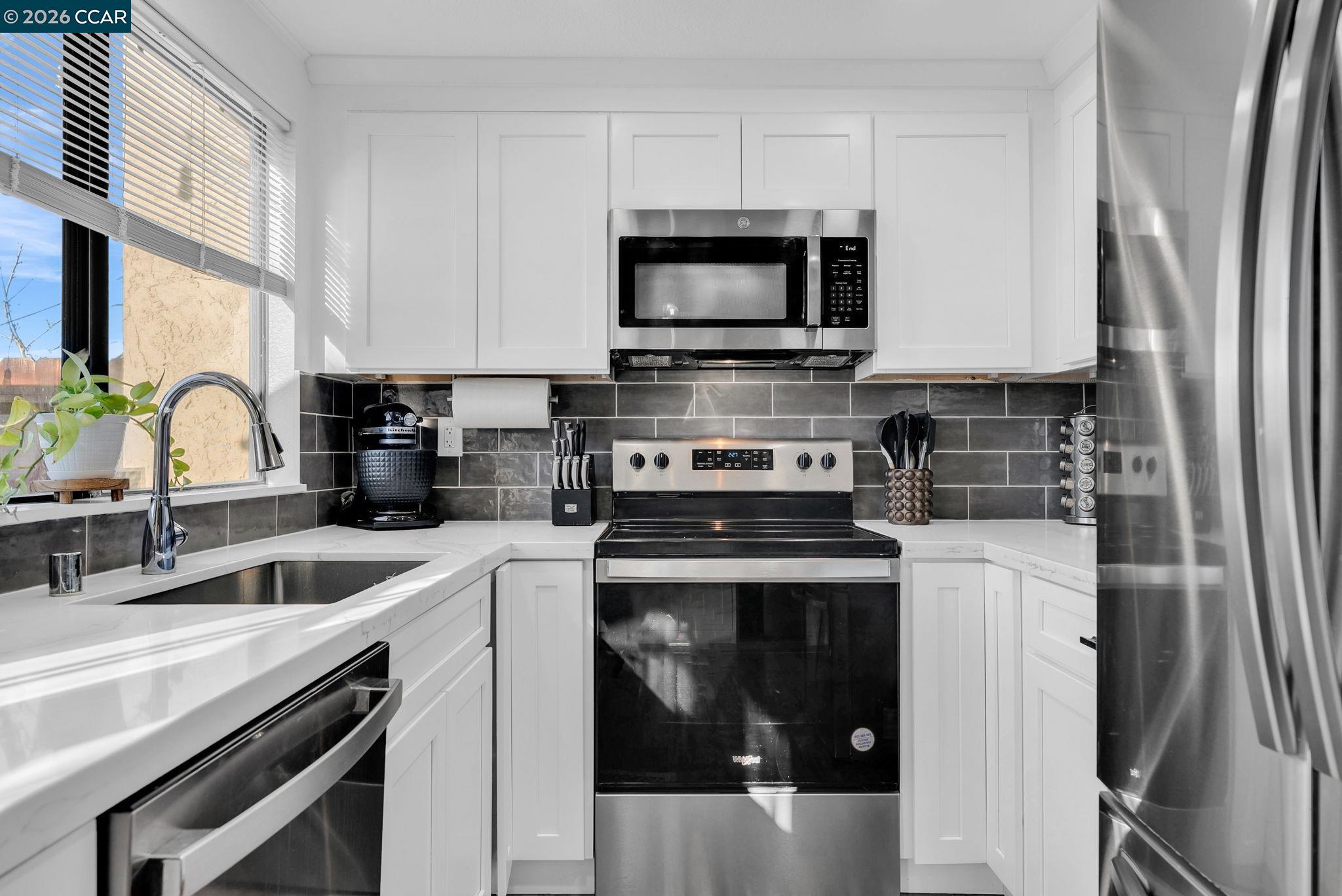 232 Case Drive Pittsburg, CA 94565 - Photo 9 of 37 a kitchen with a sink stove and microwave