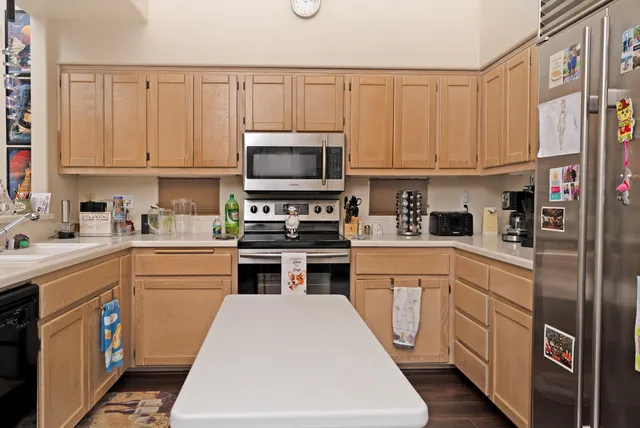 a kitchen with white cabinets and appliances