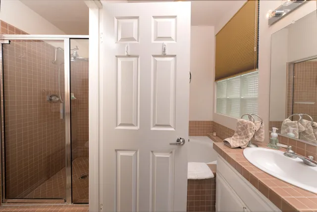 a bathroom with a double vanity sink and a mirror
