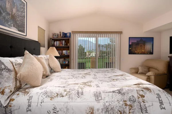 a bedroom with a large bed and a large window