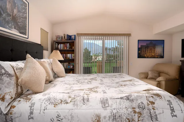 a bedroom with a large bed and a large window