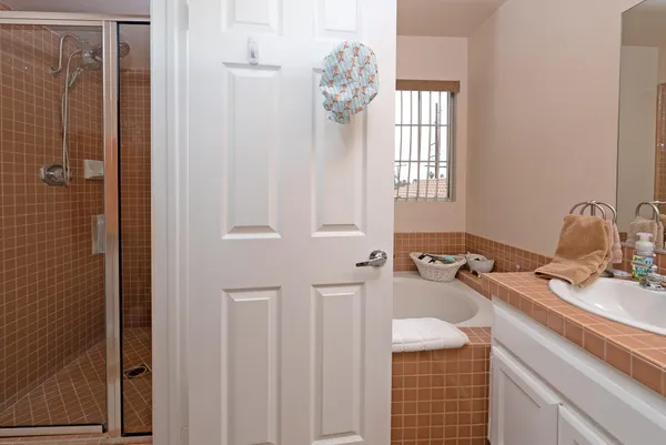 a bathroom with a window a sink and a mirror