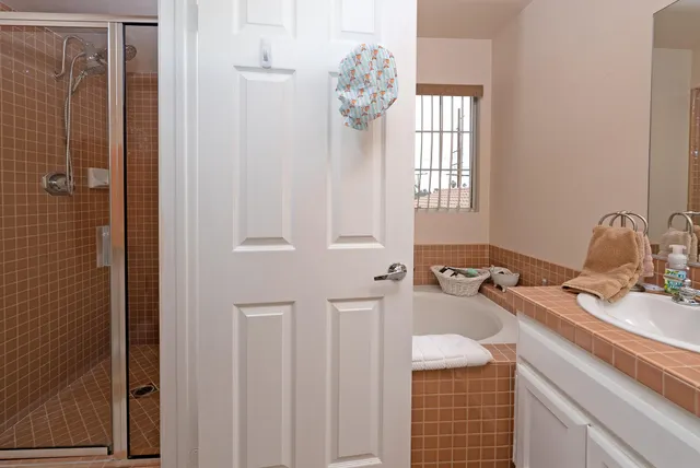 a bathroom with a window a sink and a mirror