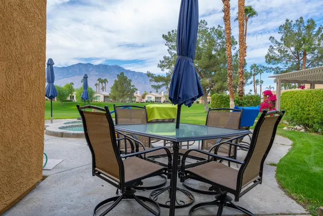 a view of a chairs and table in patio