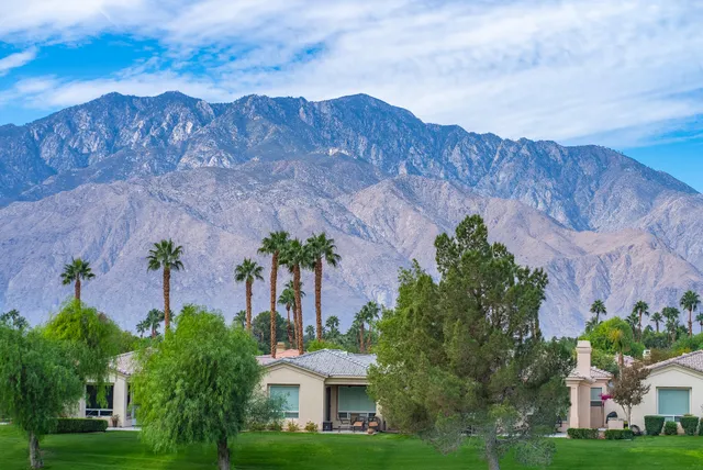 a view of a house with a garden and a yard