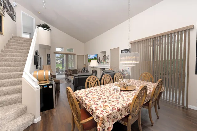 a dining room with furniture and wooden floor