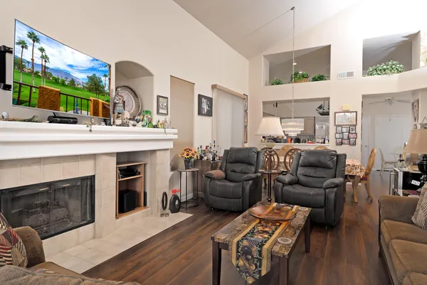 a living room with furniture a fireplace and a flat screen tv