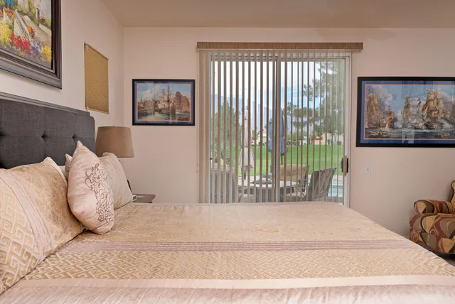 a bedroom with a bed and a painting on the wall