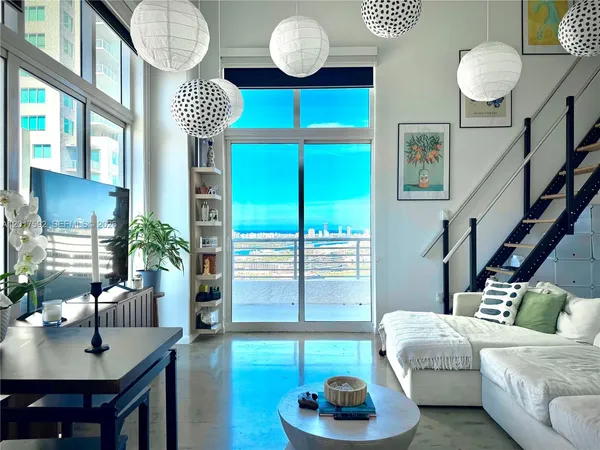 a living room with furniture and a large window