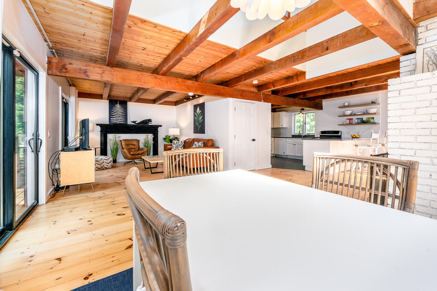 215 Gull Pond Road Wellfleet, MA 02667 - Photo 14 of 47 a living room with stainless steel appliances kitchen island granite countertop a table chairs in it and wooden floor
