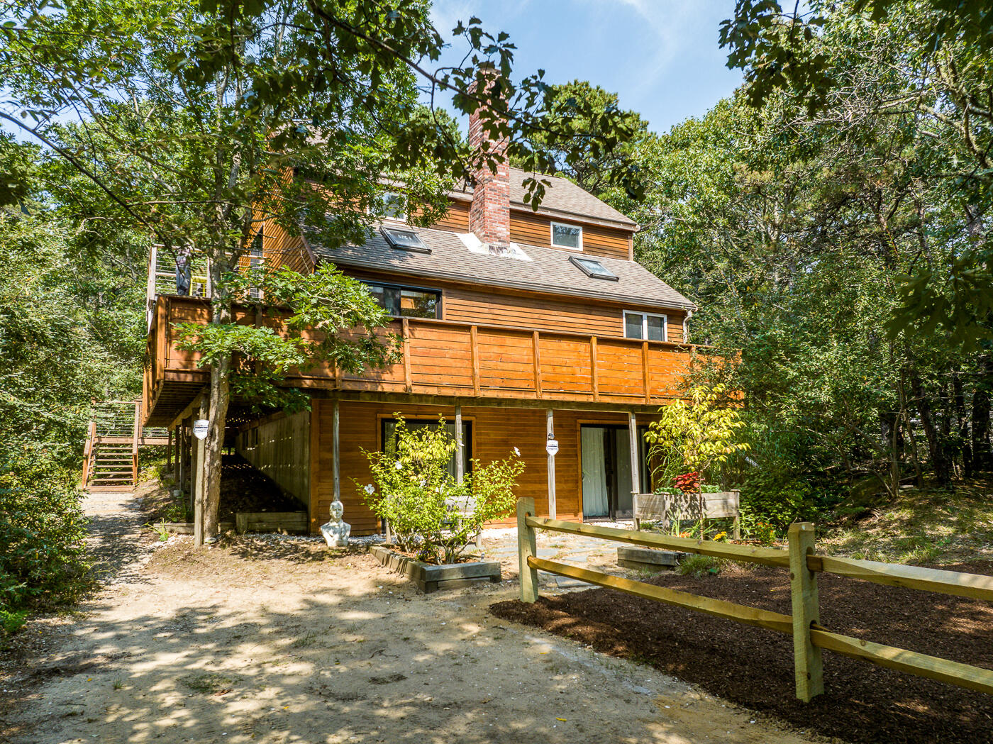 215 Gull Pond Road Wellfleet, MA 02667 - Photo 2 of 47 a front view of a house with a garden