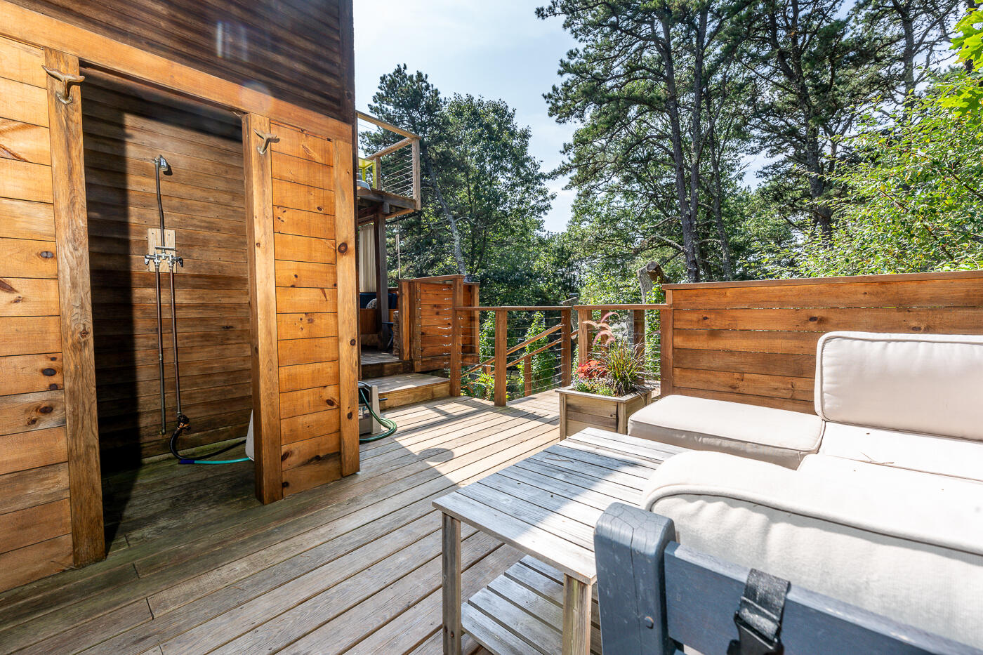 215 Gull Pond Road Wellfleet, MA 02667 - Photo 31 of 47 a view of a patio with table and chairs with wooden floor and fence