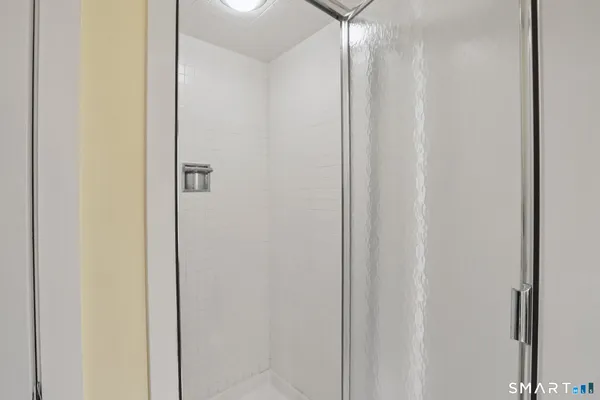 a bathroom with a shower and a mirror