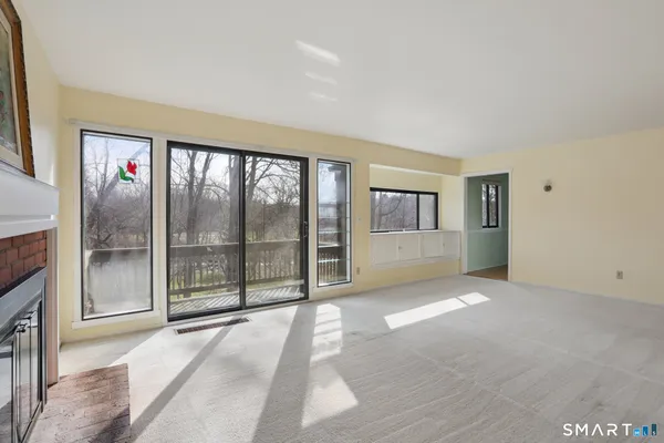 a view of an empty room with glass door