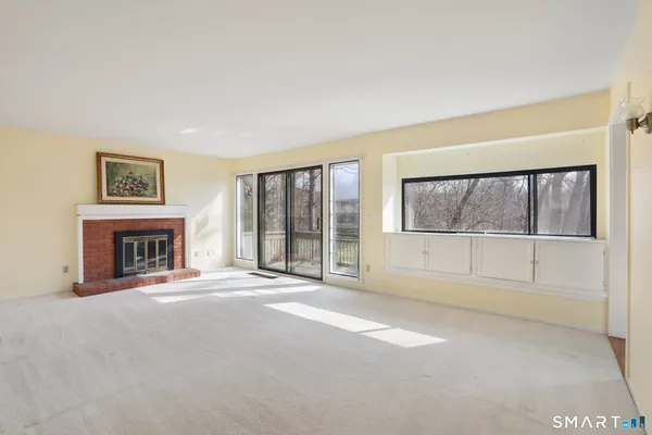 a view of an empty room with a fireplace