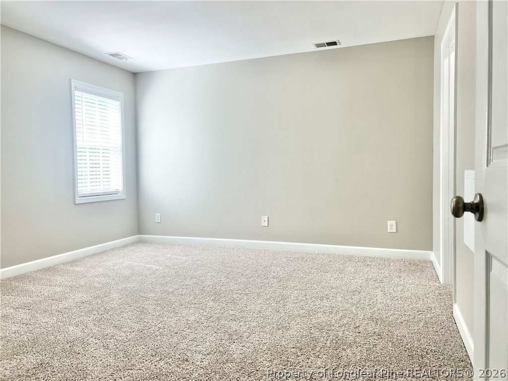1523 Rough Rider Lane Parkton, NC 28371 - Photo 33 of 42 an empty room with windows and closet