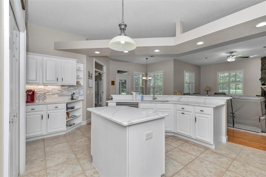 1989 Northwest 111th Loop Ocala, FL 34475 - Photo 17 of 55 a kitchen with white cabinets appliances and a fireplace