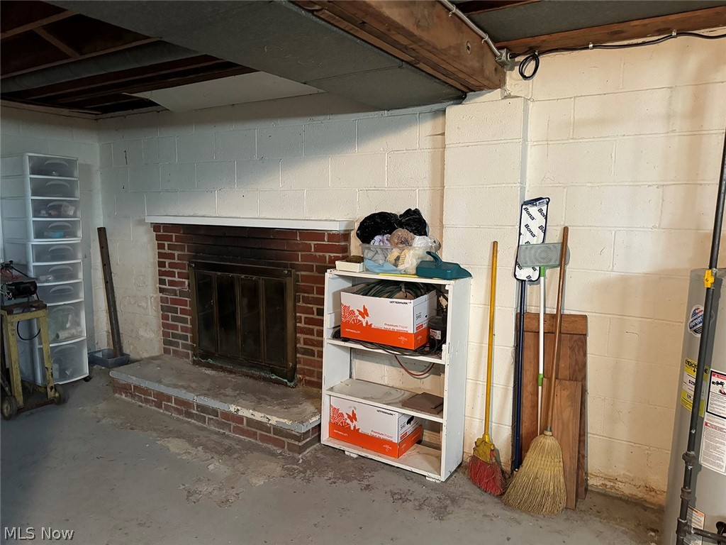 5934 Ryan Road Medina, OH 44256 - Photo 16 of 24 Basement featuring water heater and a brick fireplace