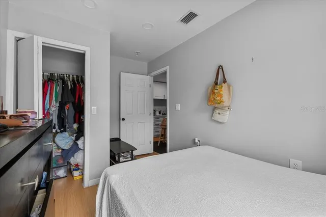 a bedroom with a bed and a desk