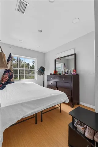 a bedroom with a bed and a window