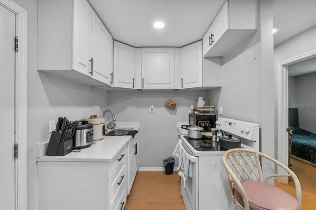 a kitchen with stainless steel appliances a sink a stove and a refrigerator